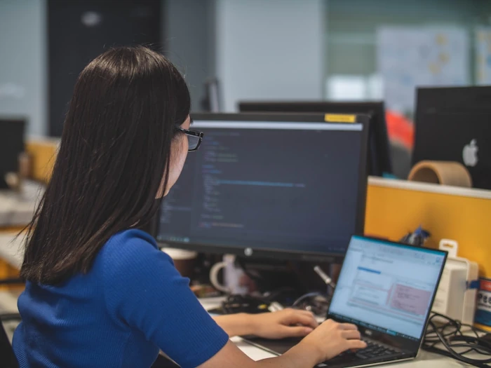 A woman in an office researching intelligent search on her computer